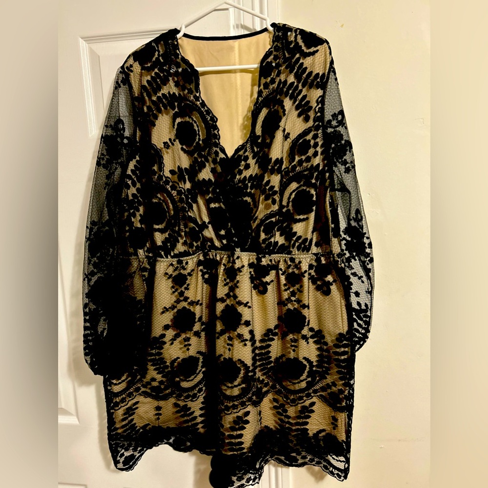 Black Italian lace dress with sheer sleeves.